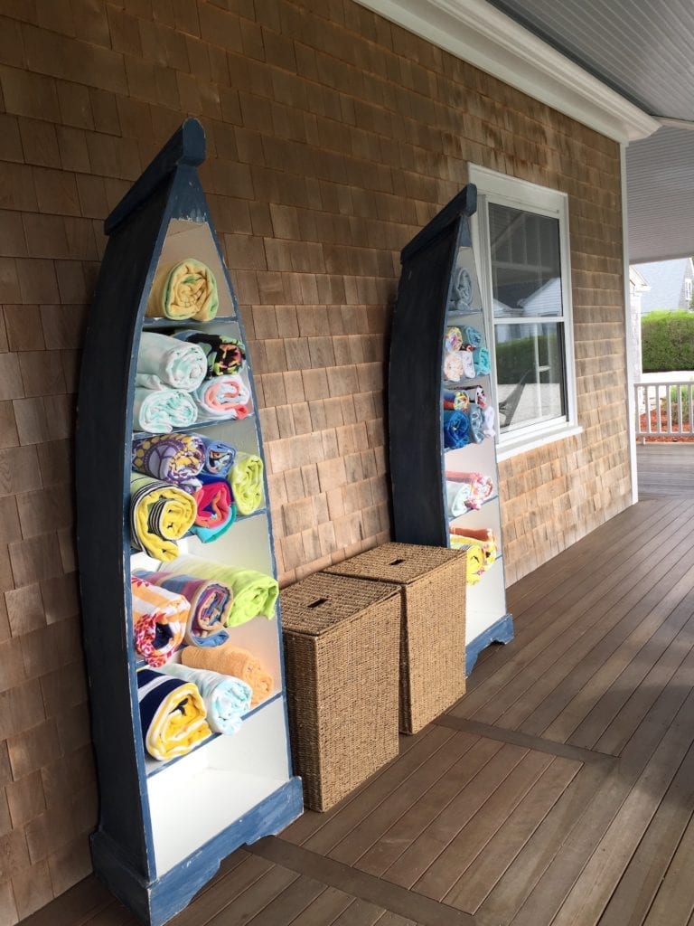 Colourful pool towels displayed in upturned boats