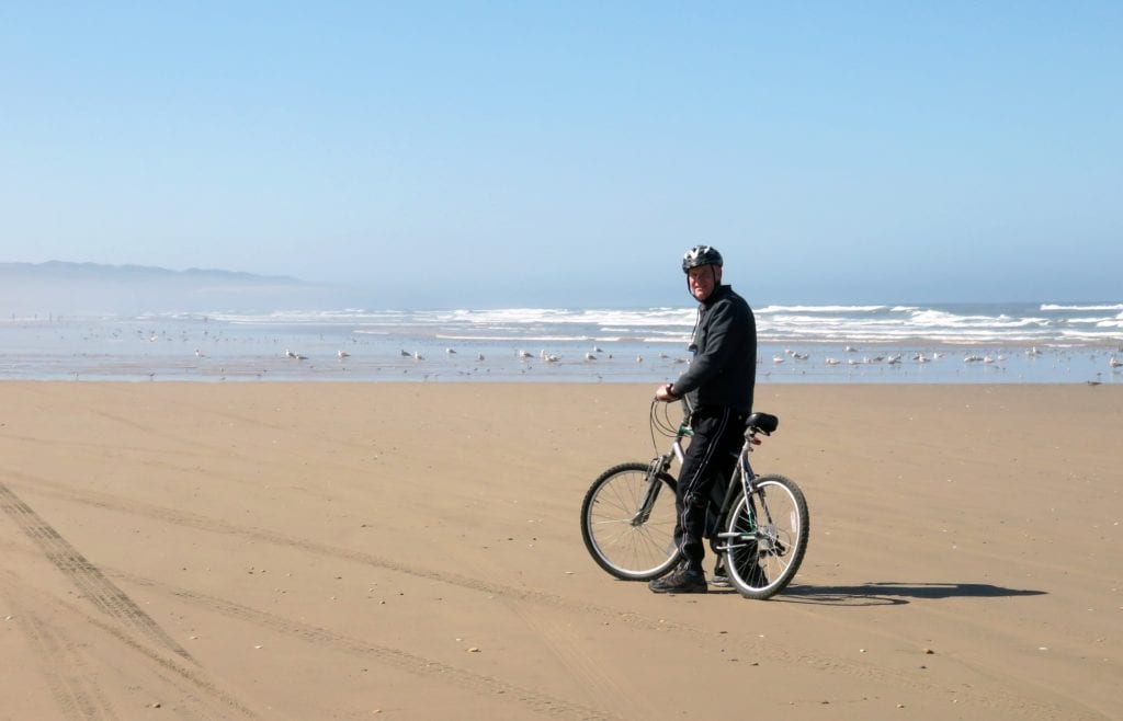 Cycling on the beach in mature years