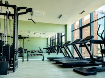 Gym with no people with exercises machines and equipment.