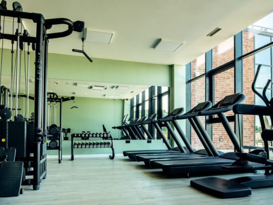 Gym with no people with exercises machines and equipment.